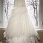 white-brides-dress-drapes-in-window